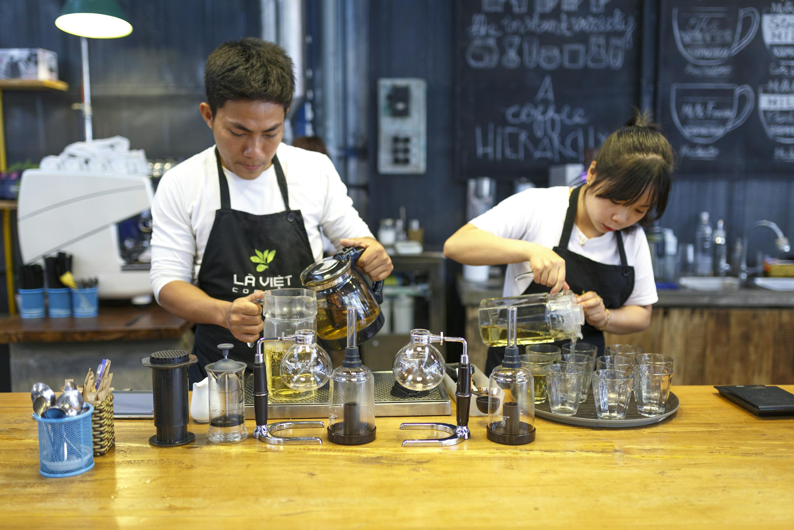 Man and Woman Standing While Holding Pitchers